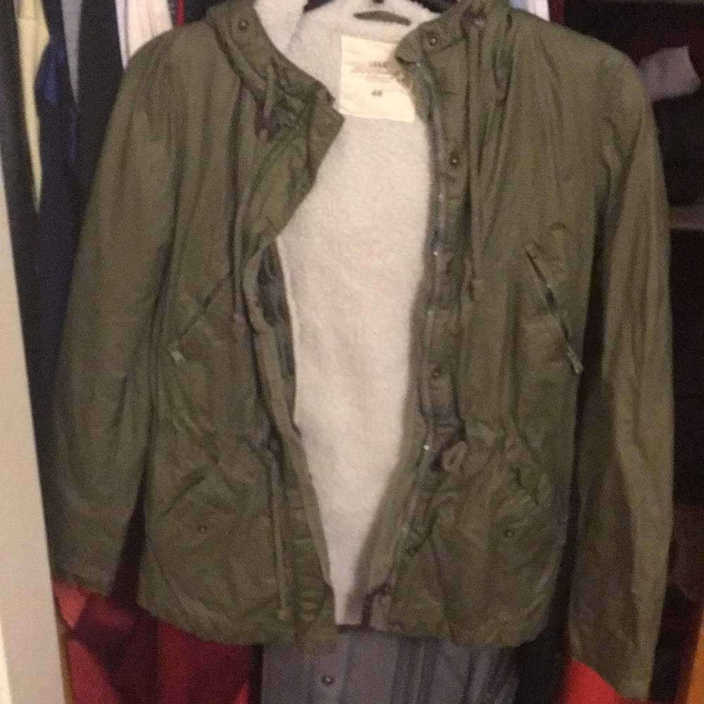 green jacket with hood and possibly faux fur insid